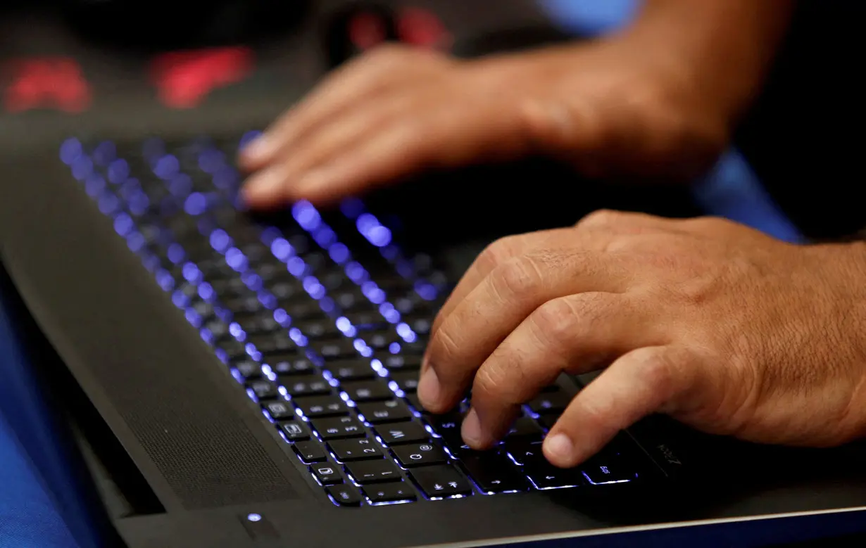 FILE PHOTO: FILE PHOTO: A man types into a keyboard during the Def Con hacker convention in Las Vegas