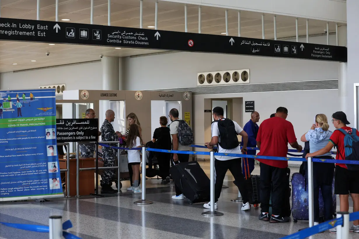 People wait in line at Lebanese customs at the Beirut–Rafic Hariri International Airport