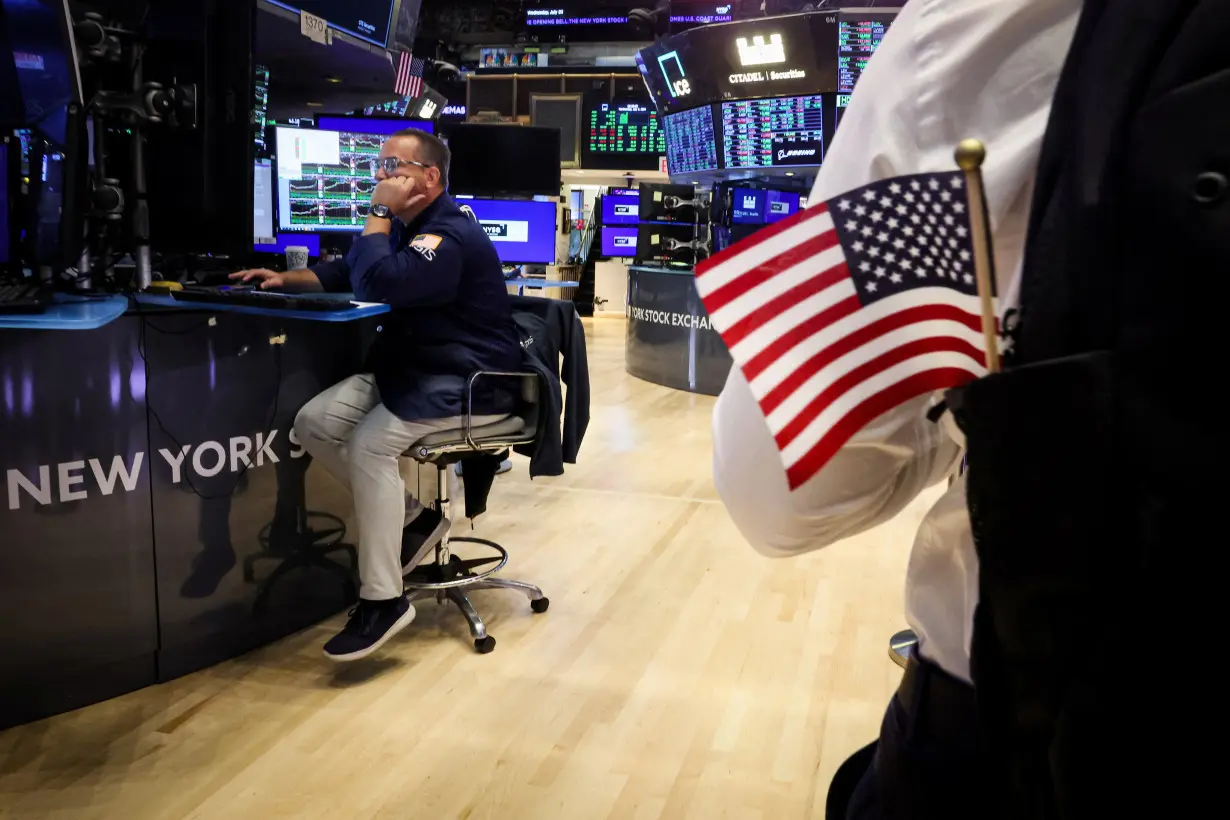 FILE PHOTO: Traders work on the floor of the NYSE in New York