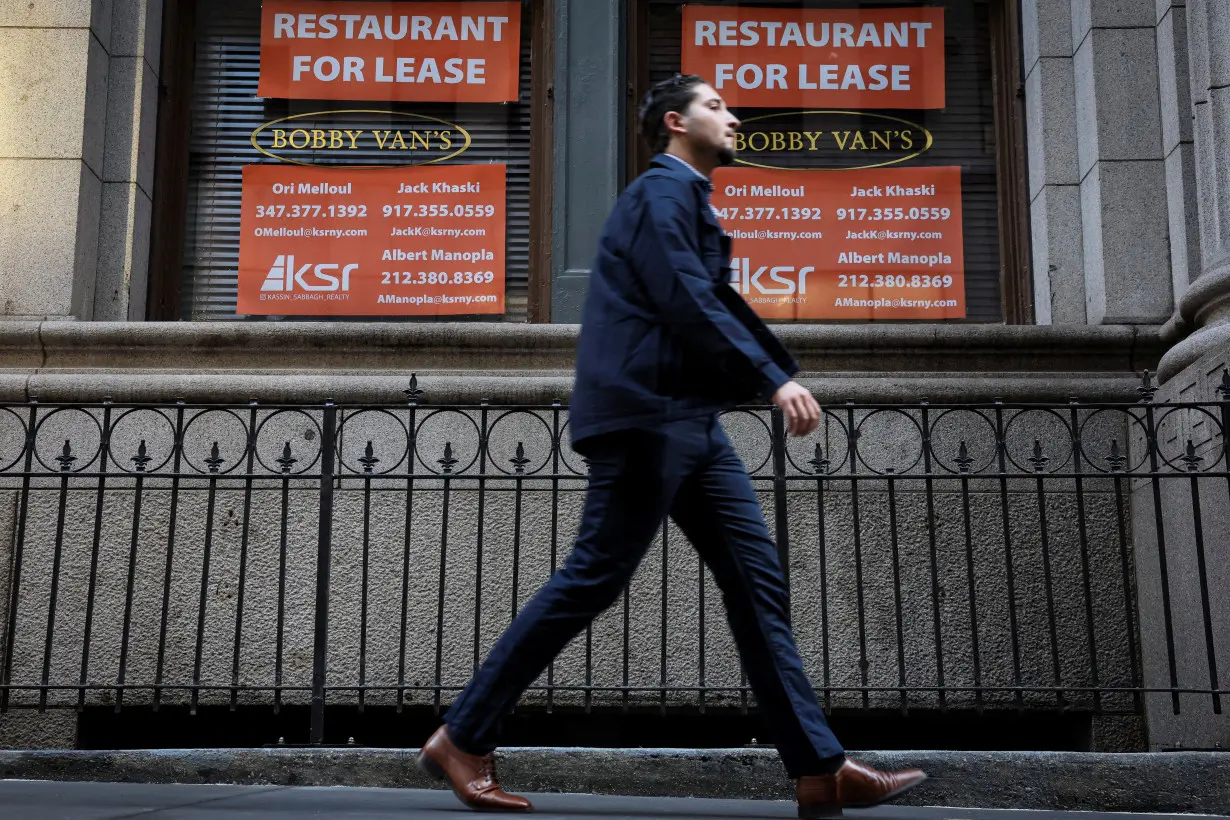 FILE PHOTO: Man walks past 