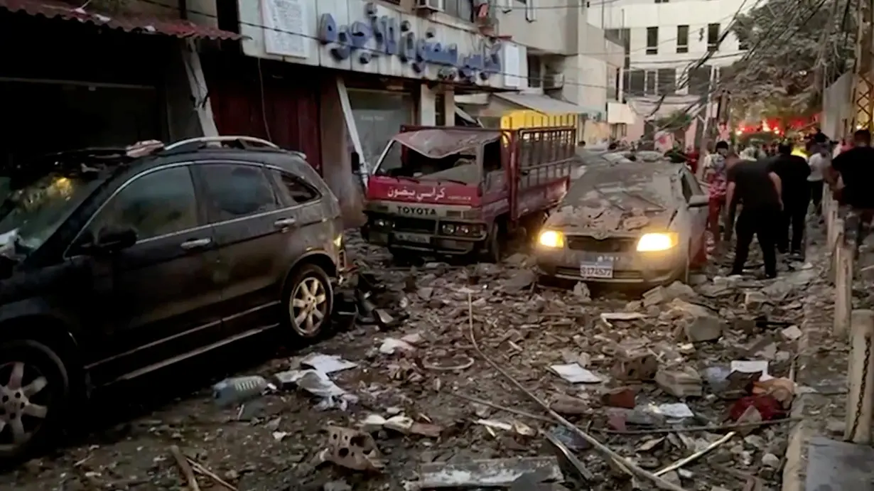 Damaged vehicles are seen after an Israeli strike on Beirut's southern suburbs