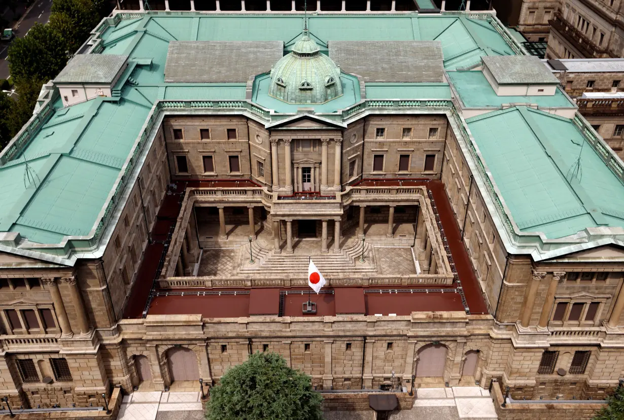 Japanese national flag is hoisted atop the headquarters of Bank of Japan in Tokyo