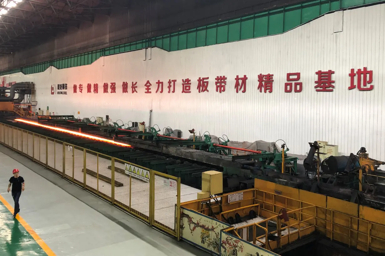 Man walks inside a steel plant of Delong Steel in Xingtai