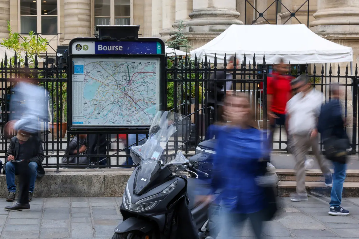 Commuters arrive at the Bourse Metro station