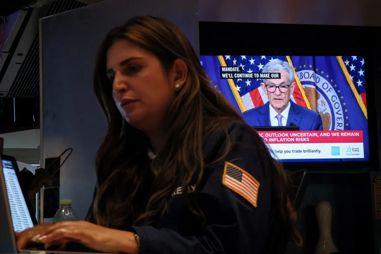 FILE PHOTO: Traders react to Fed rate announcement on the floor of the NYSE in New York