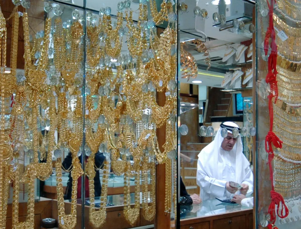 FILE PHOTO: A man pays for his purchase in a shop at the Gold Souq in Dubai