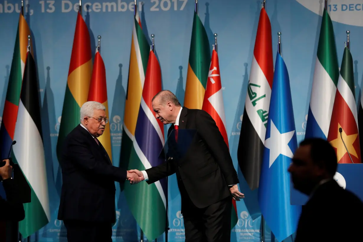 Turkish President Tayyip Erdogan and Palestinian President Mahmoud Abbas attend a news conference following the extraordinary meeting of the Organisation of Islamic Cooperation (OIC) in Istanbul