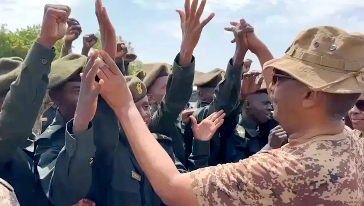 Head of Sudan's armed forces Abdel Fattah al-Burhan greets officers after drone strike hit army base, in Gebit