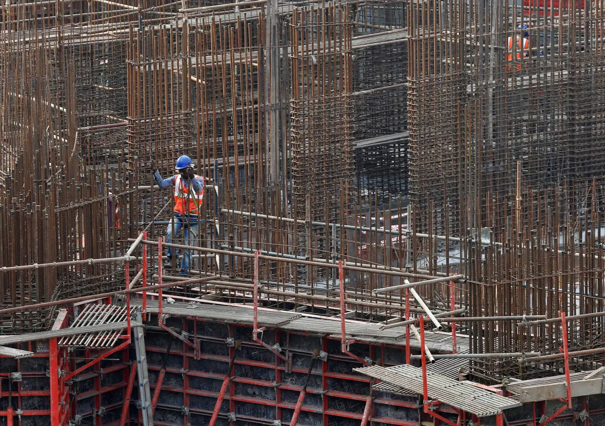 A man works on a construction site of a residential building in Mumbai