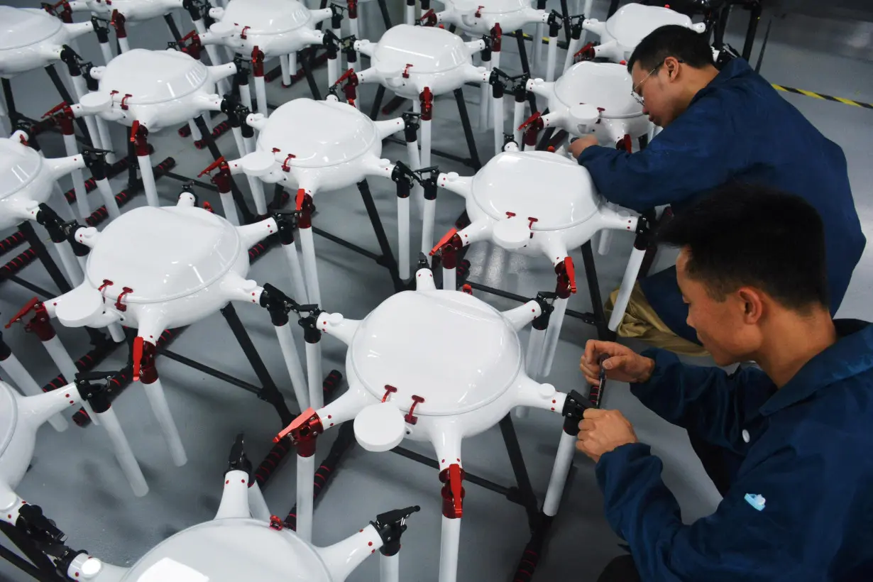 Employees work on the production line for drones at a workshop, in Anqing