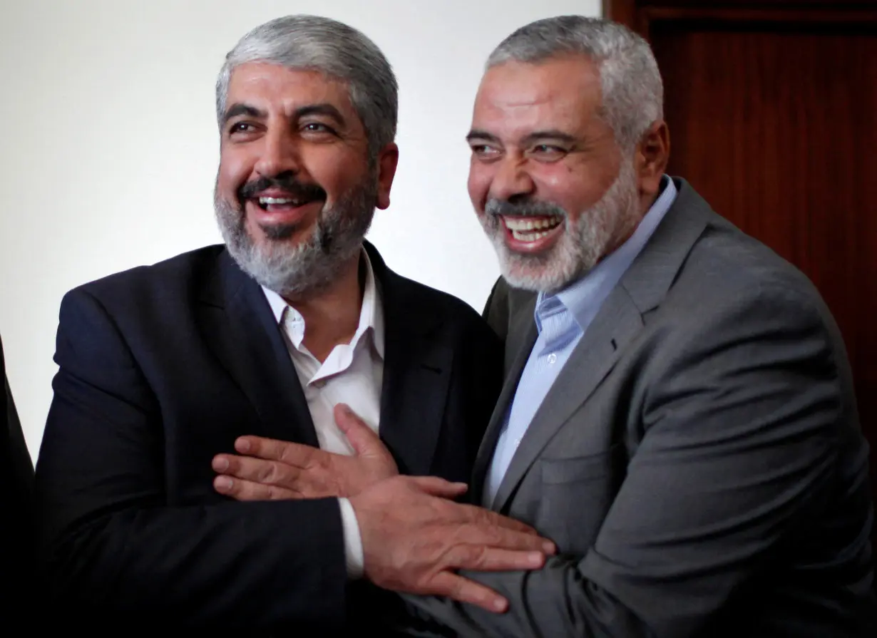 FILE PHOTO: Hamas chief Khaled Meshaal hugs senior Hamas leader Ismail Haniyeh before leaving Gaza Strip