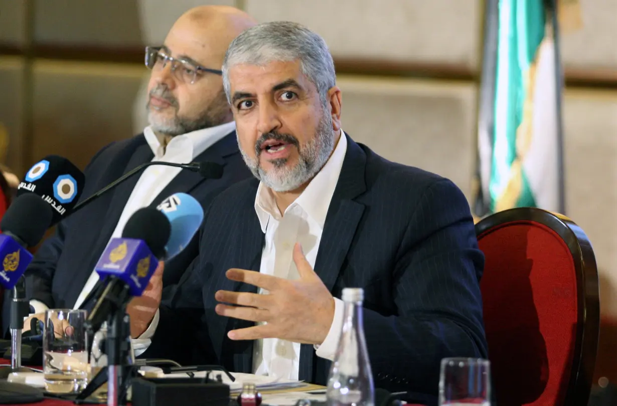 Hamas leader Khaled Meshaal gestures as he announces a new policy document in Doha