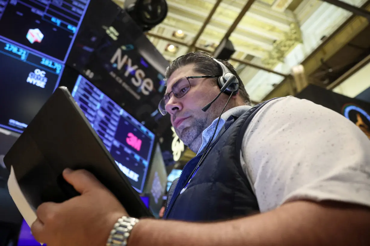 Traders work on the floor of the NYSE in New York