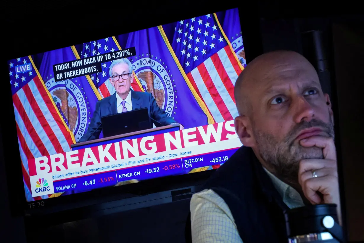 FILE PHOTO: Traders reacts to Fed rate announcement on the floor of the NYSE in New York