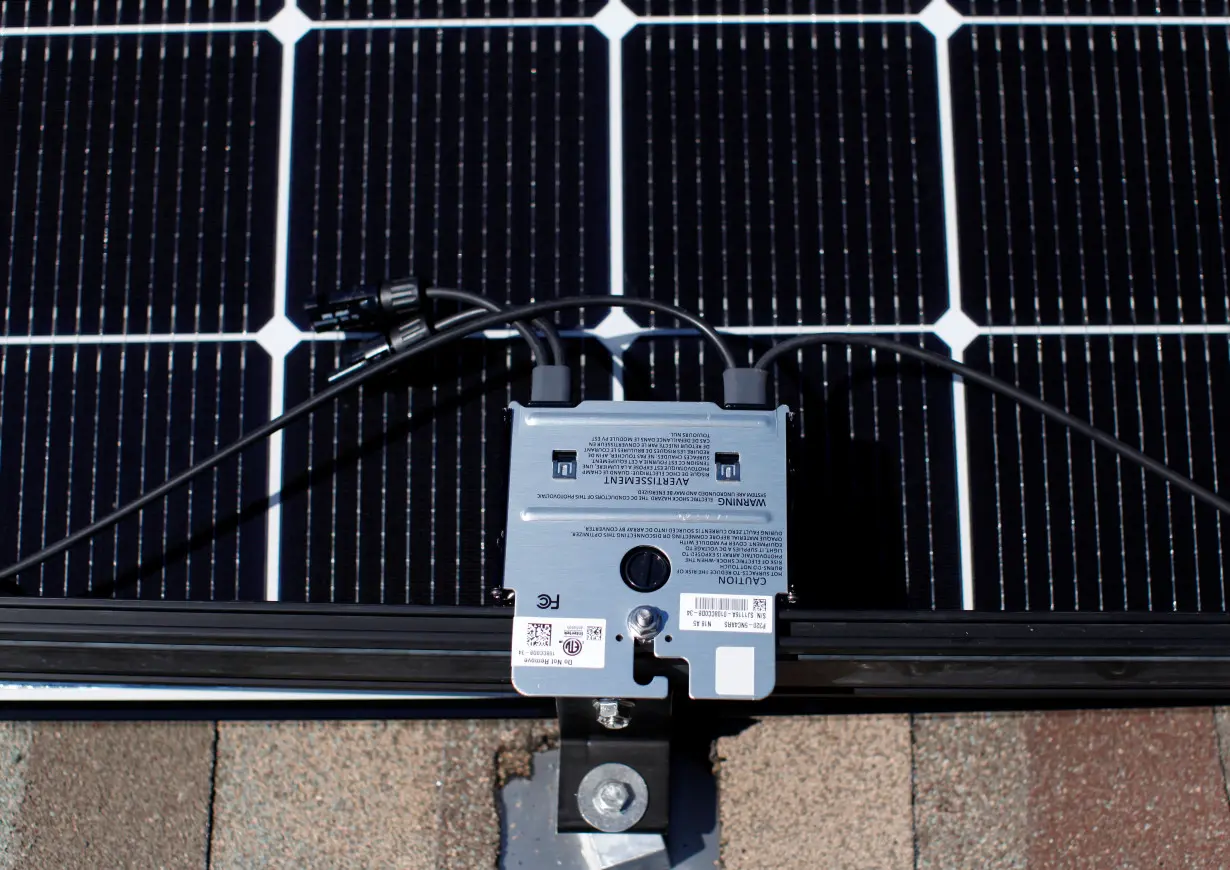 A solar panel is shown during installation on a residential roof in Scripps Ranch, San Diego