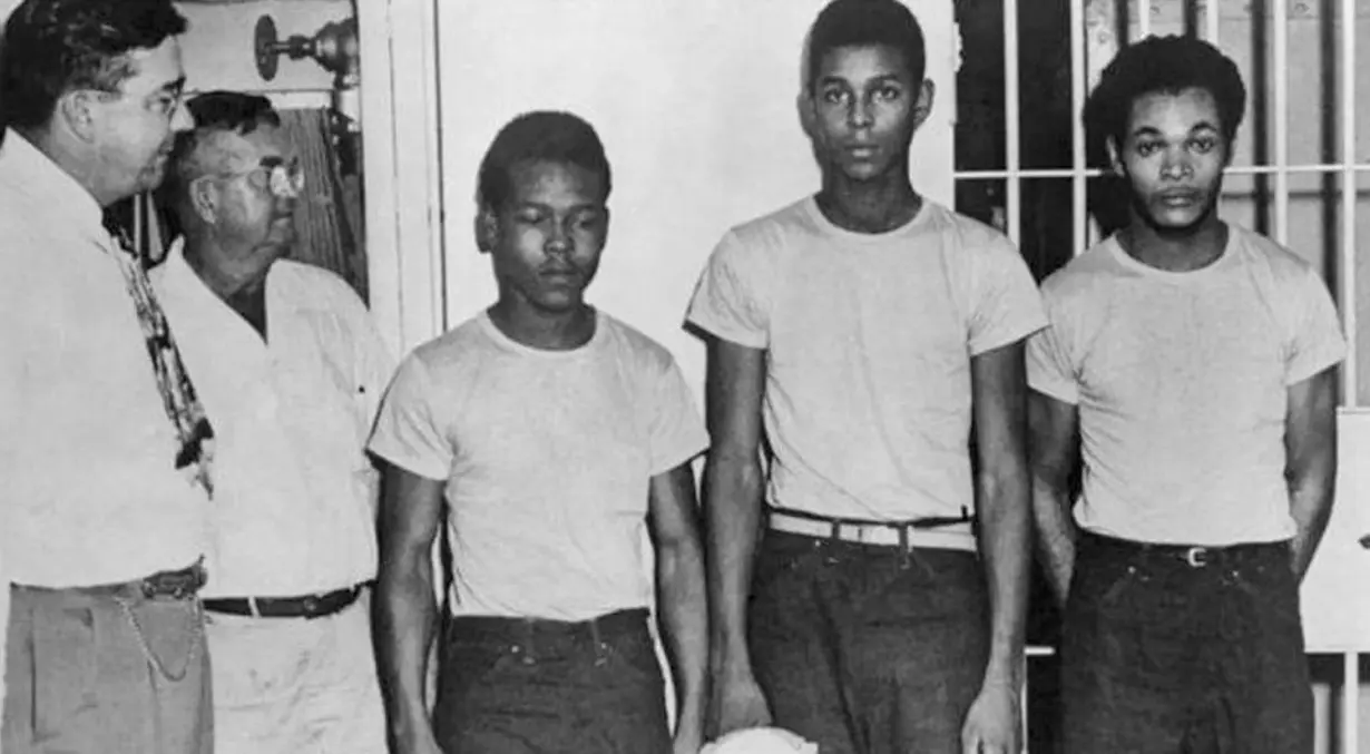 Lake County Sheriff Willis McCall, far left, and an unidentified man stand next to Walter Irvin, Samuel Shepherd, and Charles Greenlee, from left, in Florida. The three men, along with a fourth, were charged with rape in 1949.