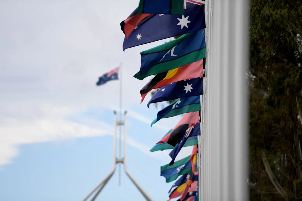 FILE PHOTO: Australian Aboriginal and Torres Strait Islander flags are pictured in front of Parliament House