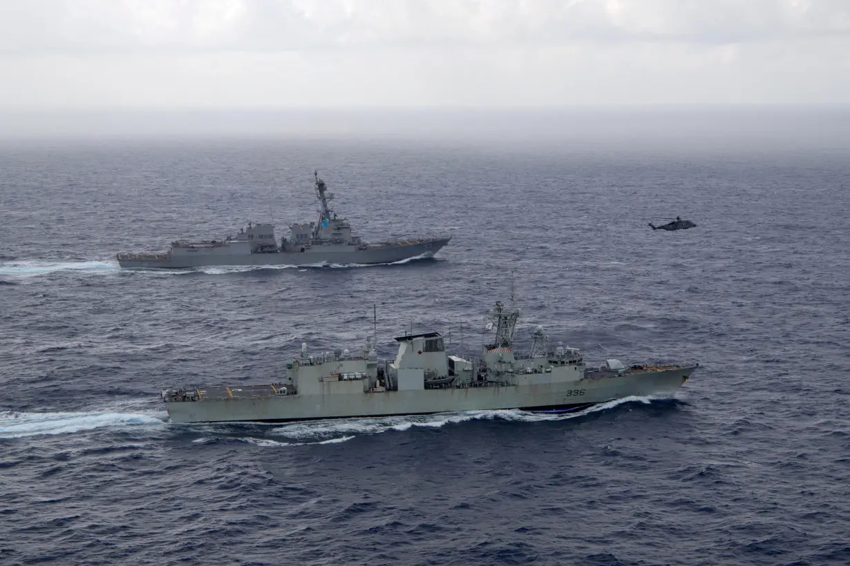 FILE PHOTO: USS Chung-Hoon sails alongside HMCS Montreal in South China Sea