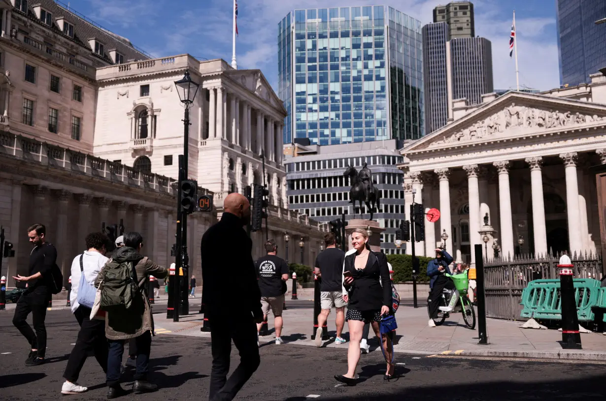 FILE PHOTO: People walk near the Bank of England and the Royal Exchange