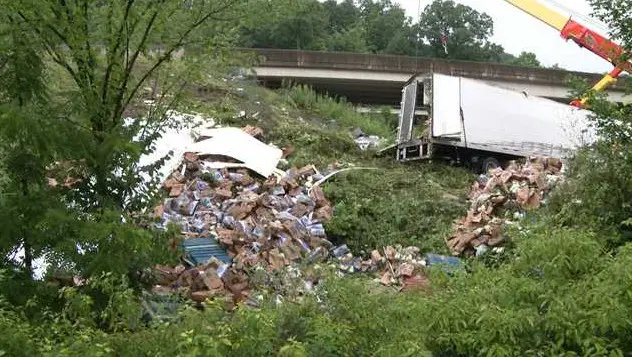 Semi-truck carrying vegetables tumbles off, sending driver to the hospital