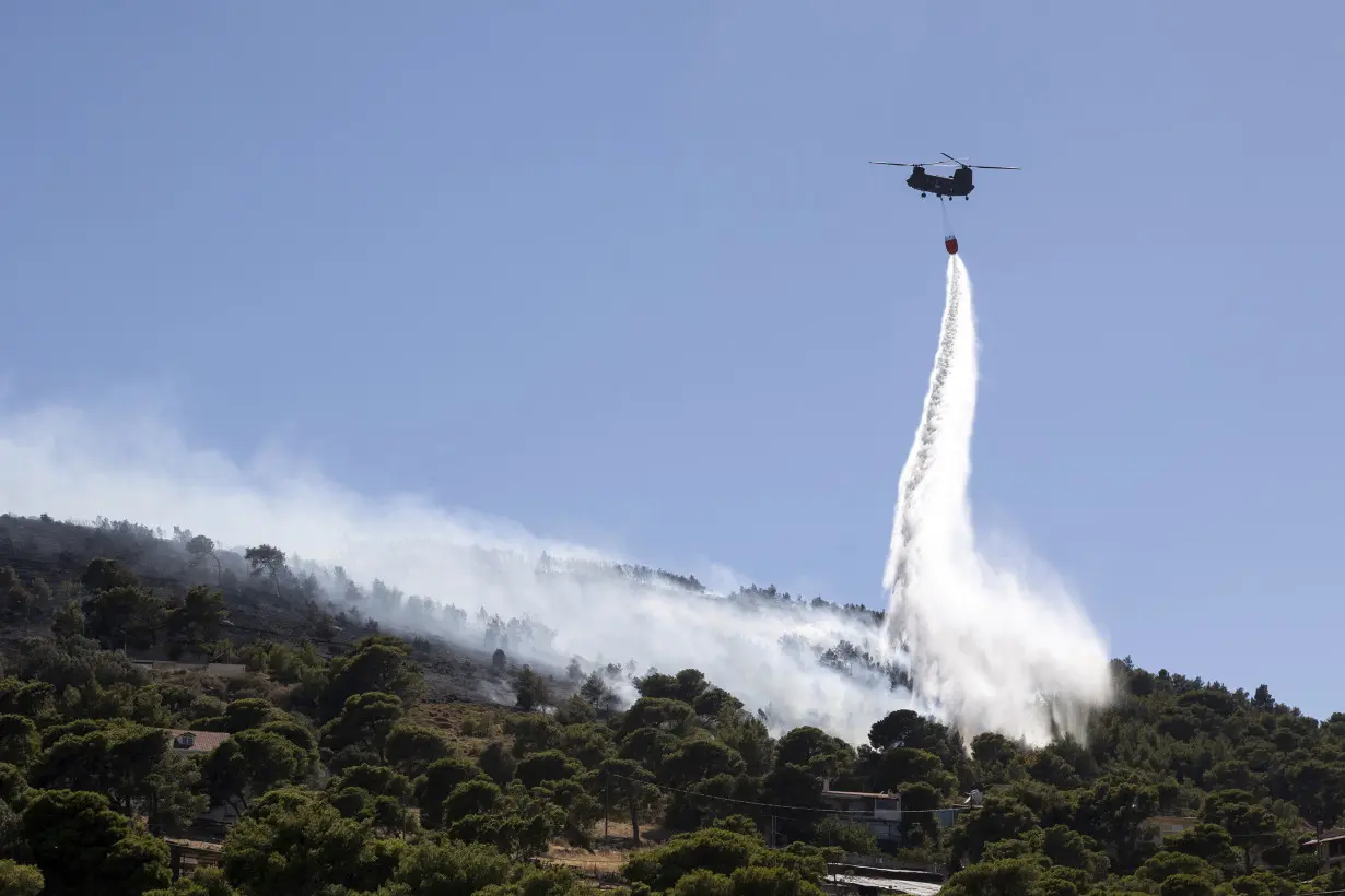 Firefighters battle wildfires on 2 Greek islands as premier warns of a dangerous summer