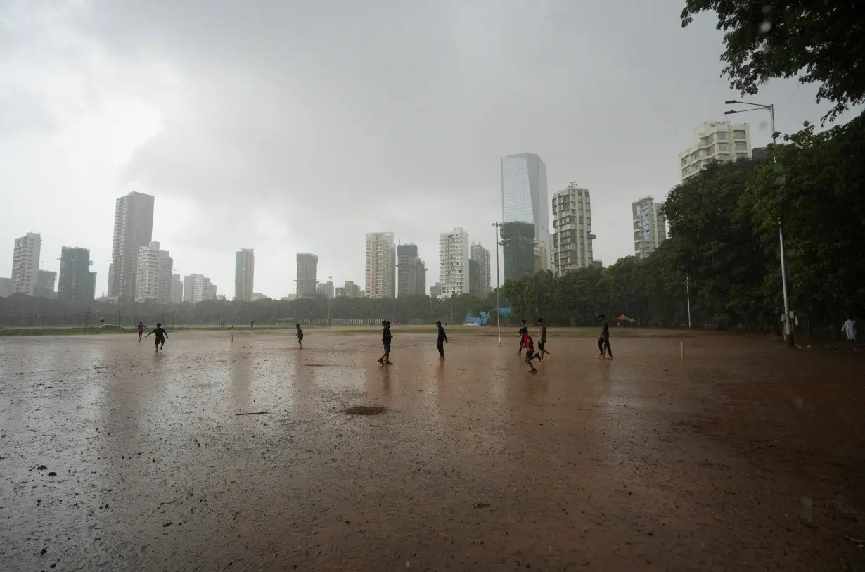 Children play in the rain in Mumbai