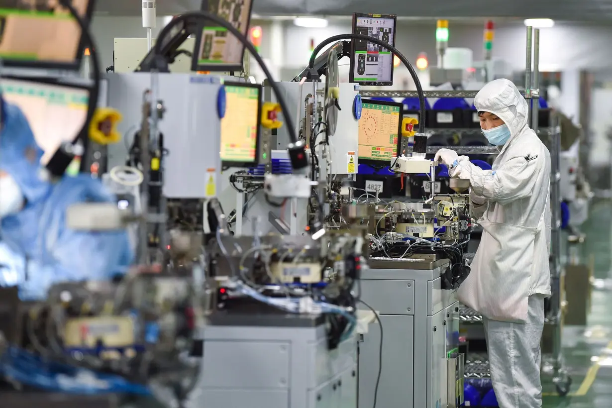 Employees operate machines at a semiconductor factory on March 1, 2023 in Siyang County, Suqian City, Jiangsu, China.