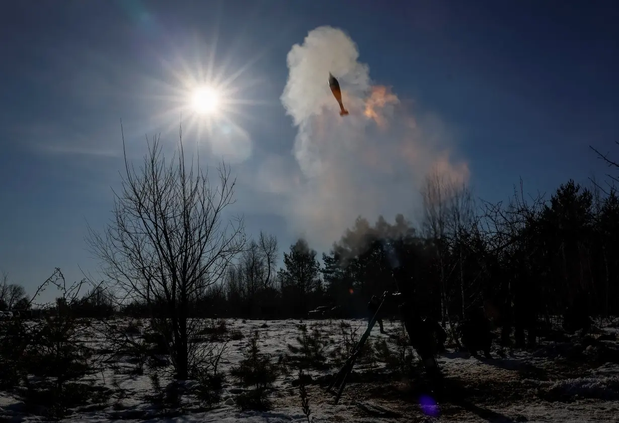 Ukrainian servicemen fire a 120-mm mortar during military exercises in Zhytomyr region