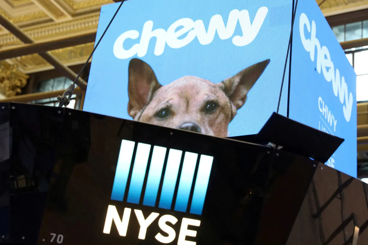 FILE PHOTO: Logos for Chewy Inc. are displayed on the trading floor on the morning of the company's IPO at the New York Stock Exchange (NYSE) in New York City