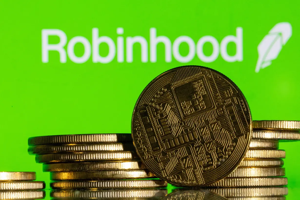 FILE PHOTO: Illustration shows Robinhood logo and representations of cryptocurrency