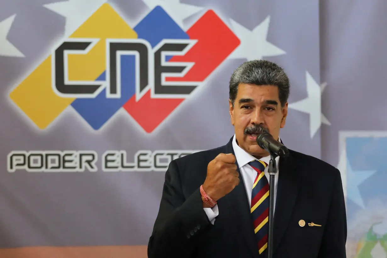 Venezuela's President Nicolas Maduro signs an agreement to recognize the electoral results of the presidential elections of July 28, in Caracas