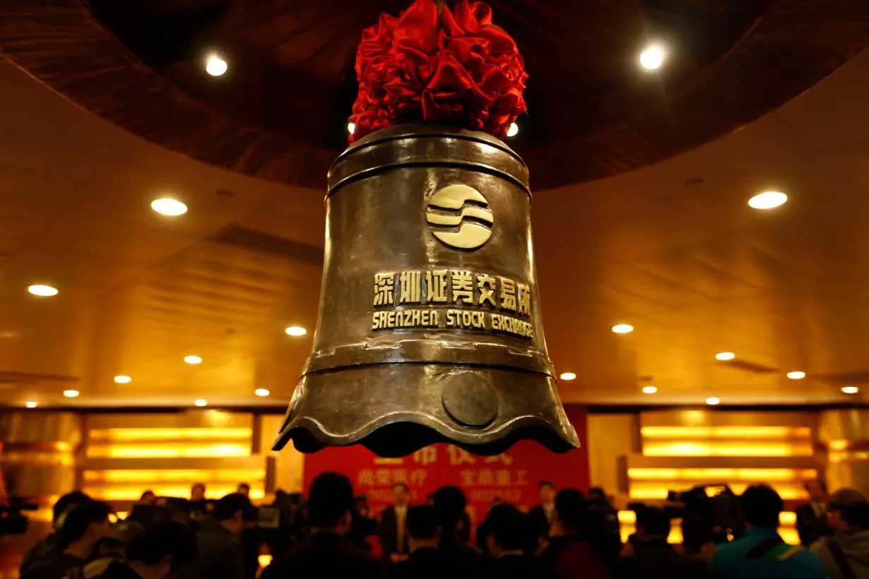 A bell bearing the logo of the Shenzhen Stock Exchange is seen during a companies listing ceremony in Shenzhen