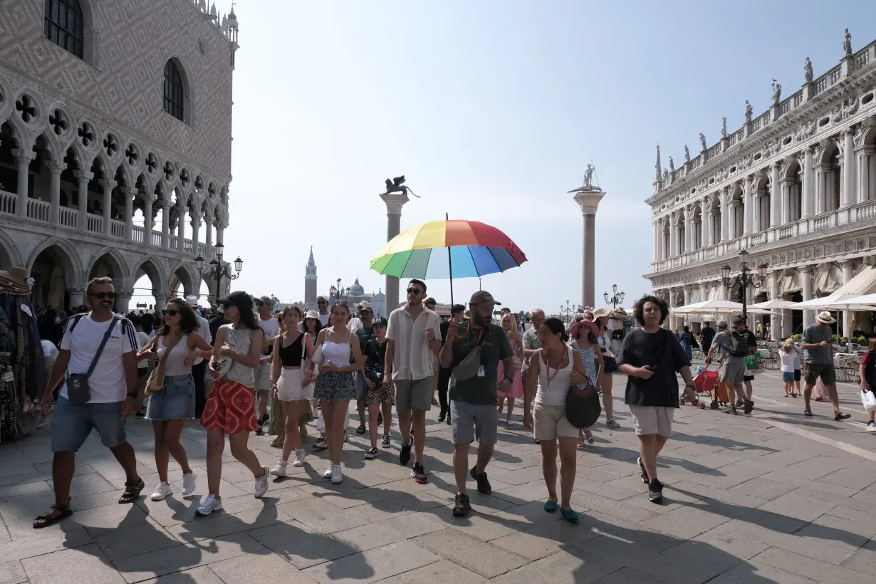 Tourist walk in Saint Marks Square on the day Venice municipality introduces a limit for tourist groups to 25 people.