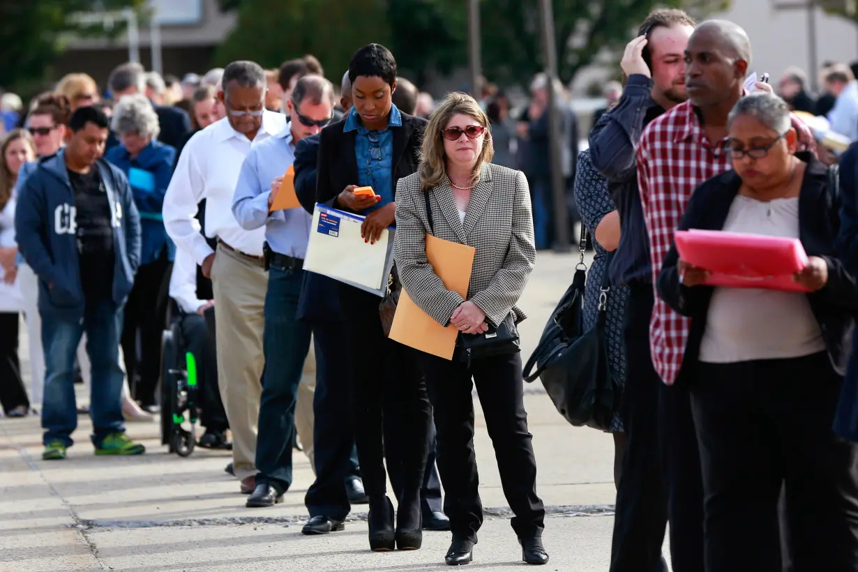 People wait in line to enter the Nassau County Mega Job Fair at Nassau Veterans Memorial Coliseum in Uniondale, New York