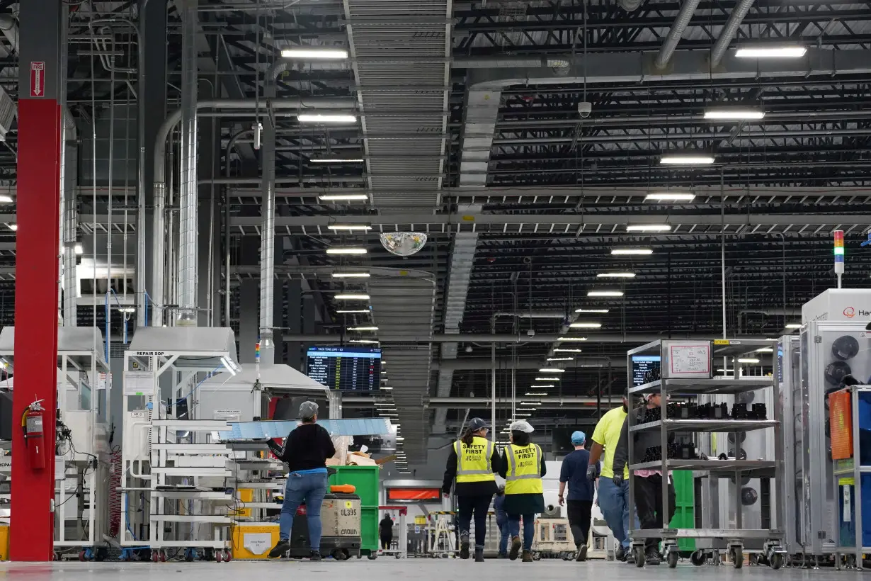 FILE PHOTO: Employees work on solar panels at the QCells solar manufacturing factory in Dalton