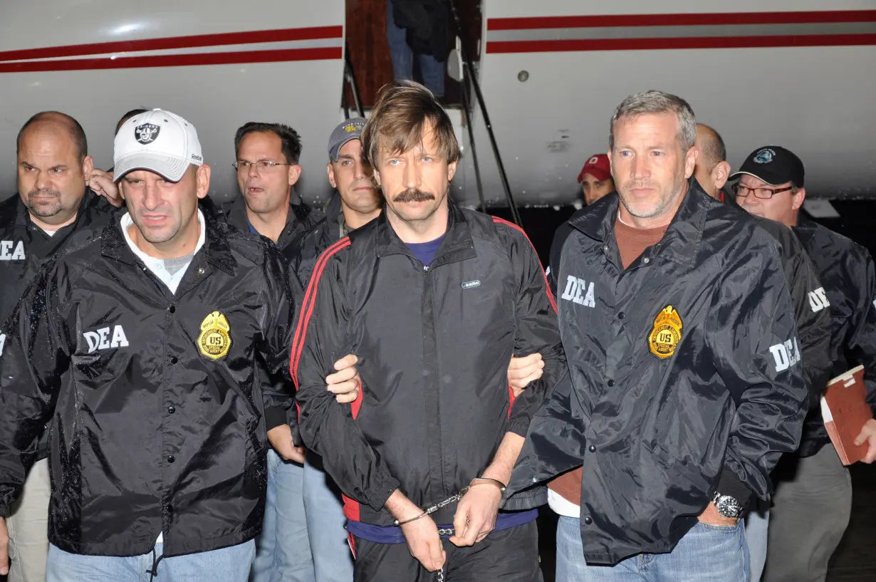 FILE PHOTO: FILE PHOTO: File handout image shows suspected Russian arms dealer Bout is escorted by DEA officers after arriving in New York