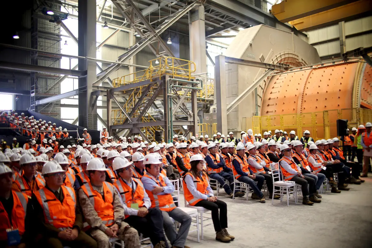 FILE PHOTO: Workers gather during a ceremony at Escondida copper mine near Antofagasta