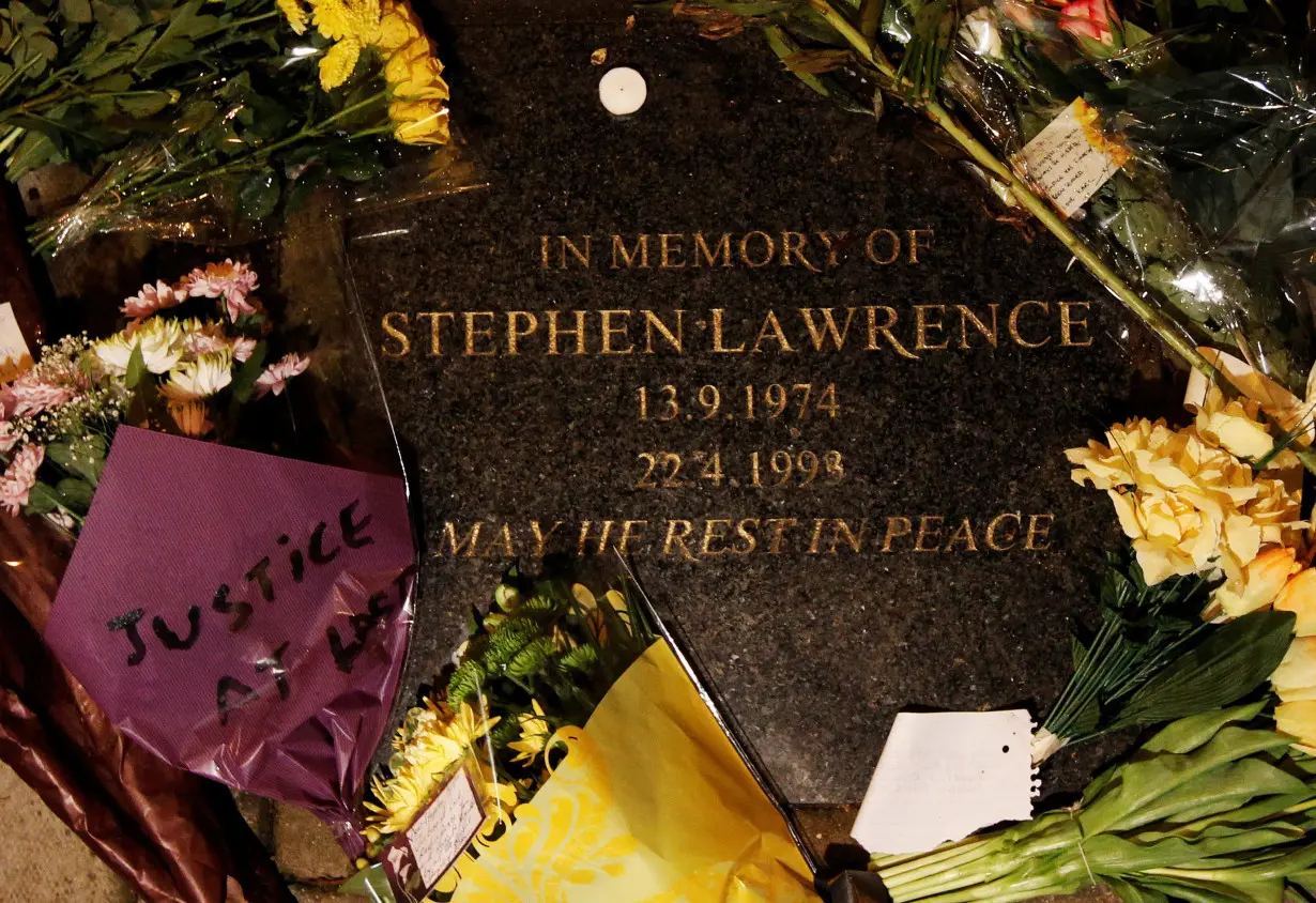 FILE PHOTO: Flowers and messages of Justice at Last are left on the memorial stone to murdered teenager Stephen Lawrence, at the place where he died in Eltham south-east London