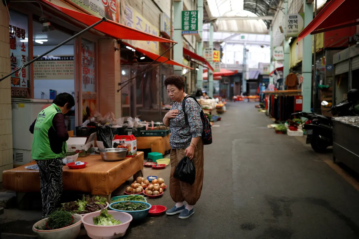 A woman shops at a traditional market in Ulsan