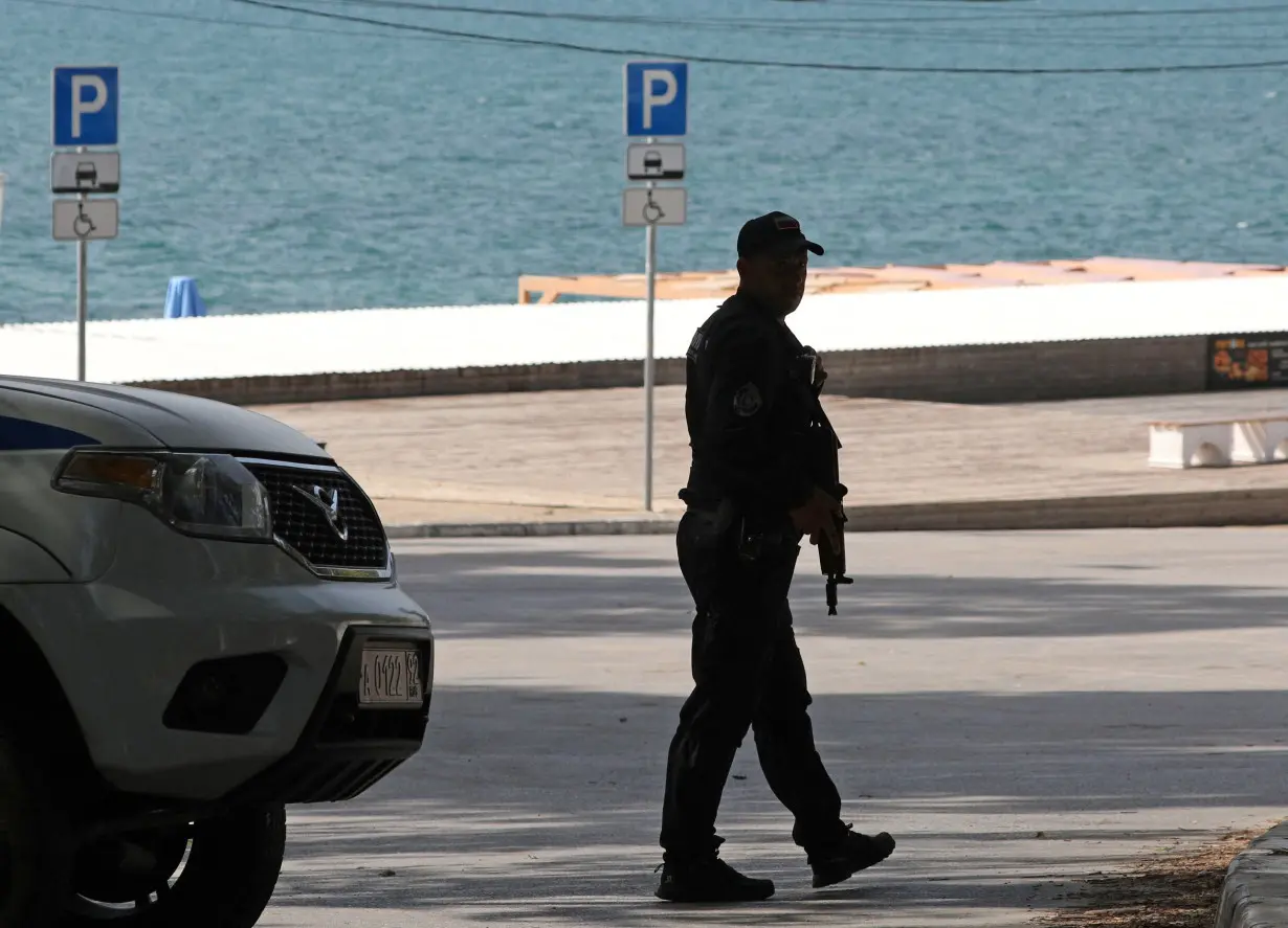 A police officer stands guard near a beach in Sevastopol