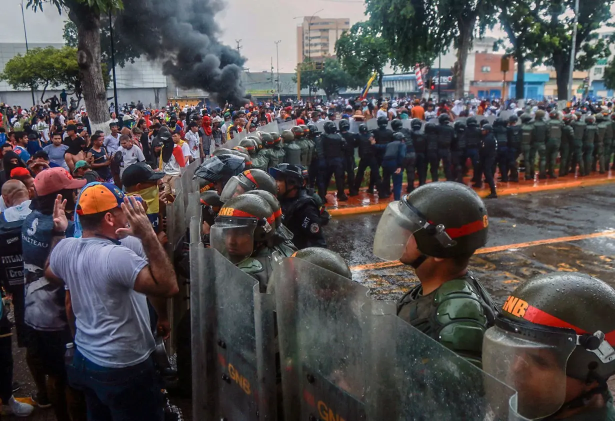 Demonstrators confront riot police during a protest against Venezuelan President Nicolas Maduro's government in Puerto La Cruz, Anzoategui state, Venezuela on July 29, 2024.