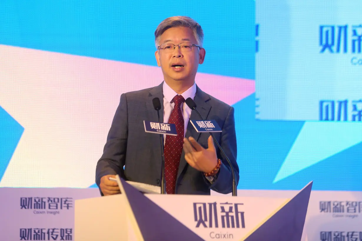 Huang Yiping, Peking University professor and China's central bank policy adviser, speaks at the financial forum Caixin Summit in Beijing