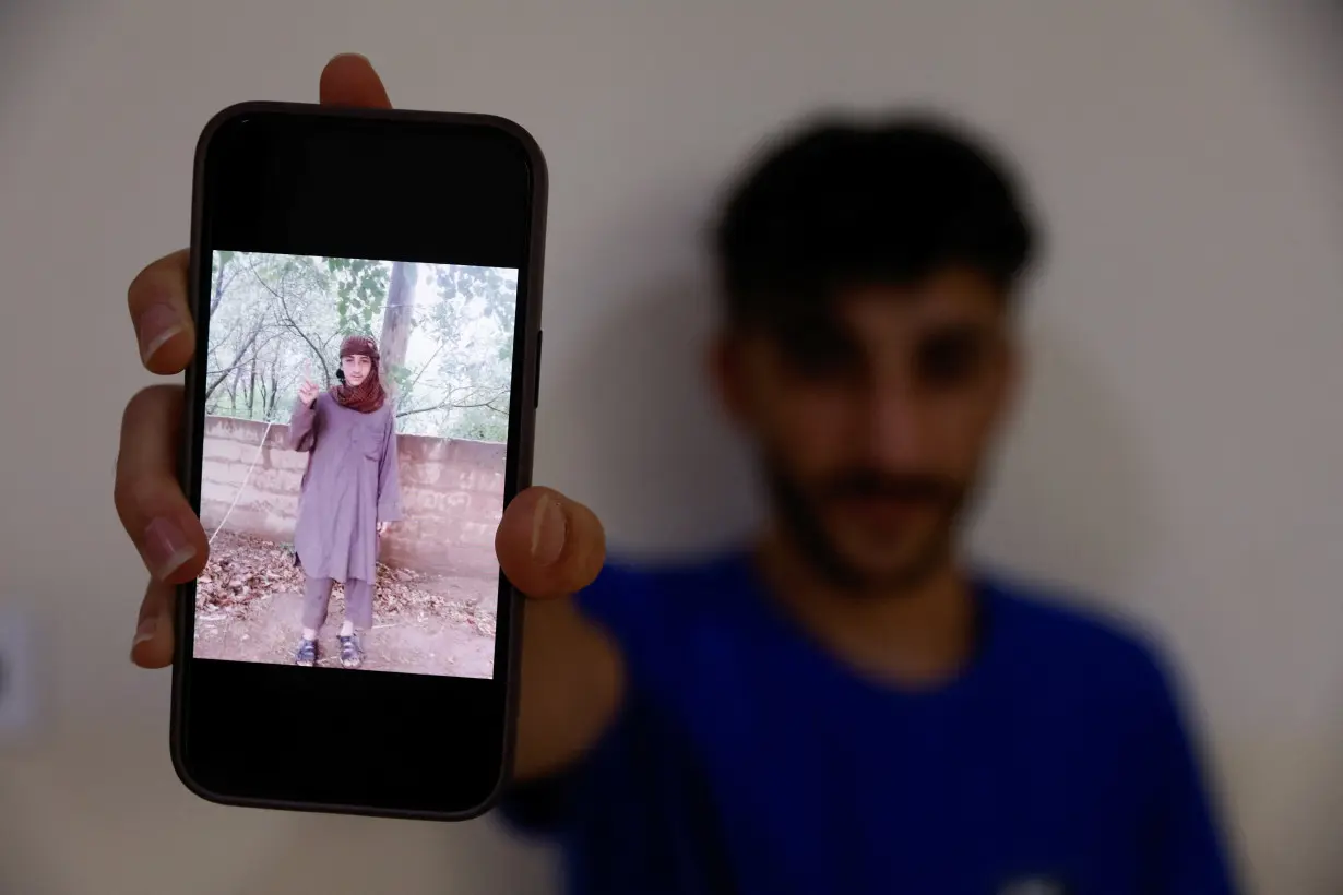 Fahad Qasim, 21, Yazidi survivor displays a picture taken during the time he was kidnapped by Islamic state in Syria, in Duhok