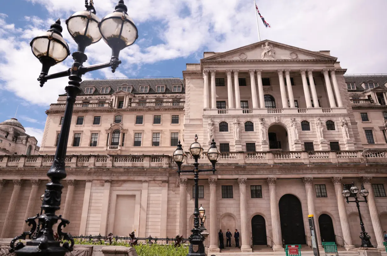 People stand next to the Bank of England