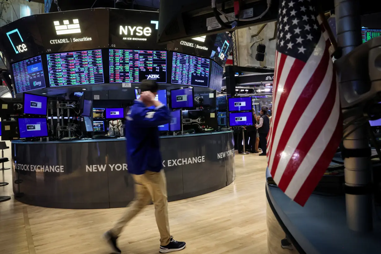 Traders work on the floor of the NYSE in New York