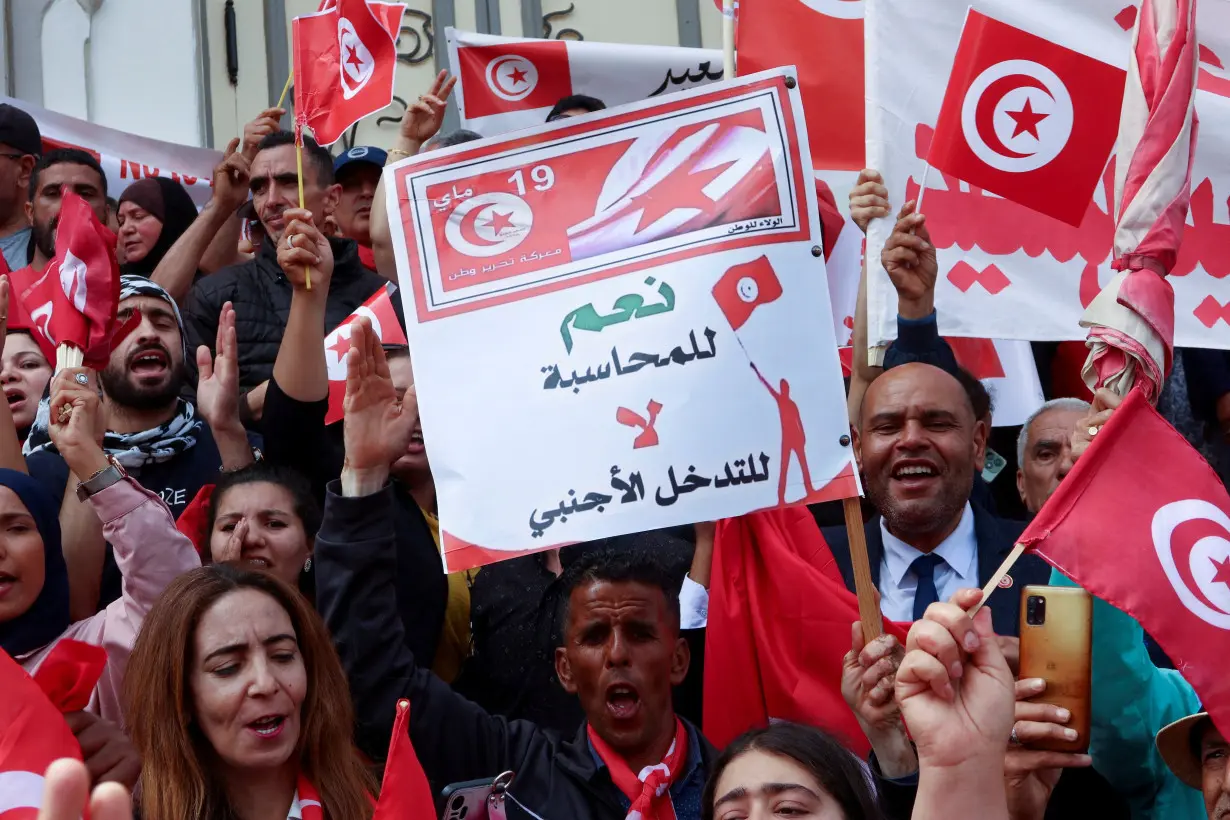 FILE PHOTO: Supporters of Tunisian President Kais Saied carry flags and signs during a demonstration in Tunis