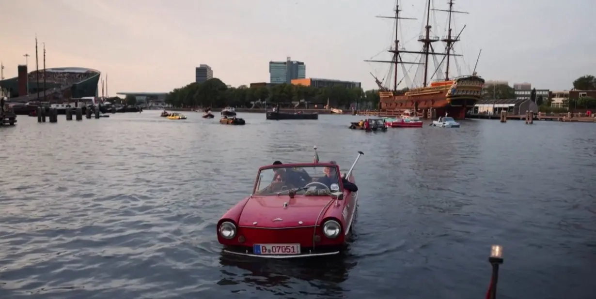 Amphibious vehicles glide through Amsterdam's canals