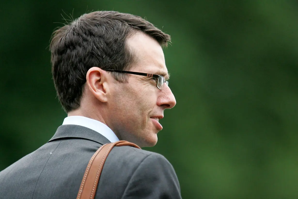 White House senior adviser Plouffe walks to the Marine One helicopter to depart with U.S. President Obama for a day trip, from the White House in Washington