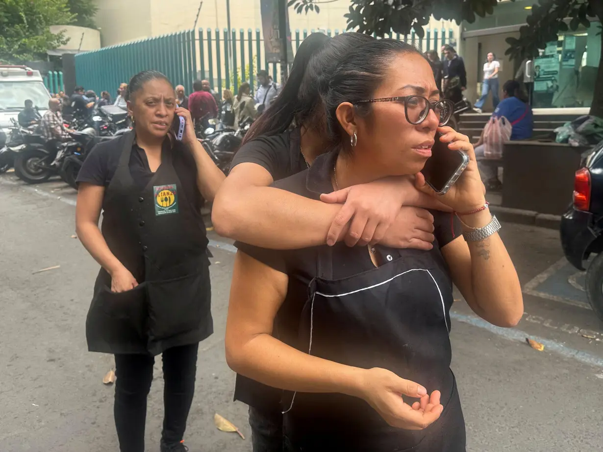 People wait outside their homes and buildings in Mexico City