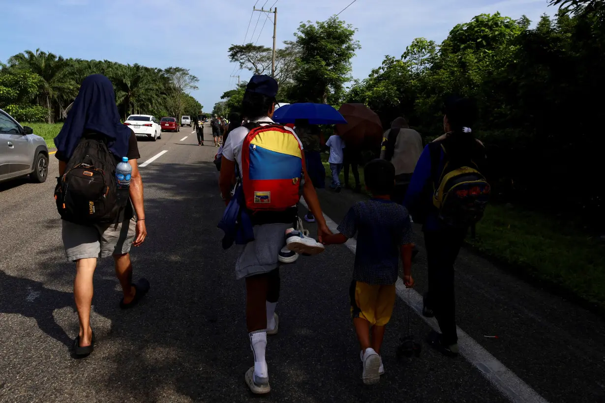 Migrants continue their journey toward the U.S. border, in Villa Comaltitlan